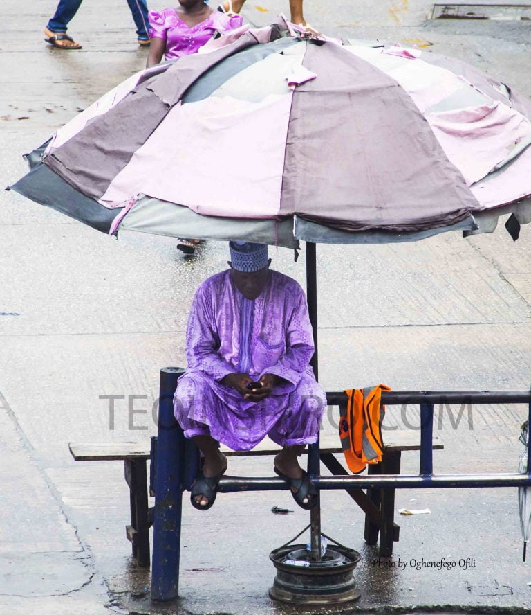 A-black-market-forex-trader-under-his-umbrella-prepared-for-any-weather-as-he-awaits-potential-clients